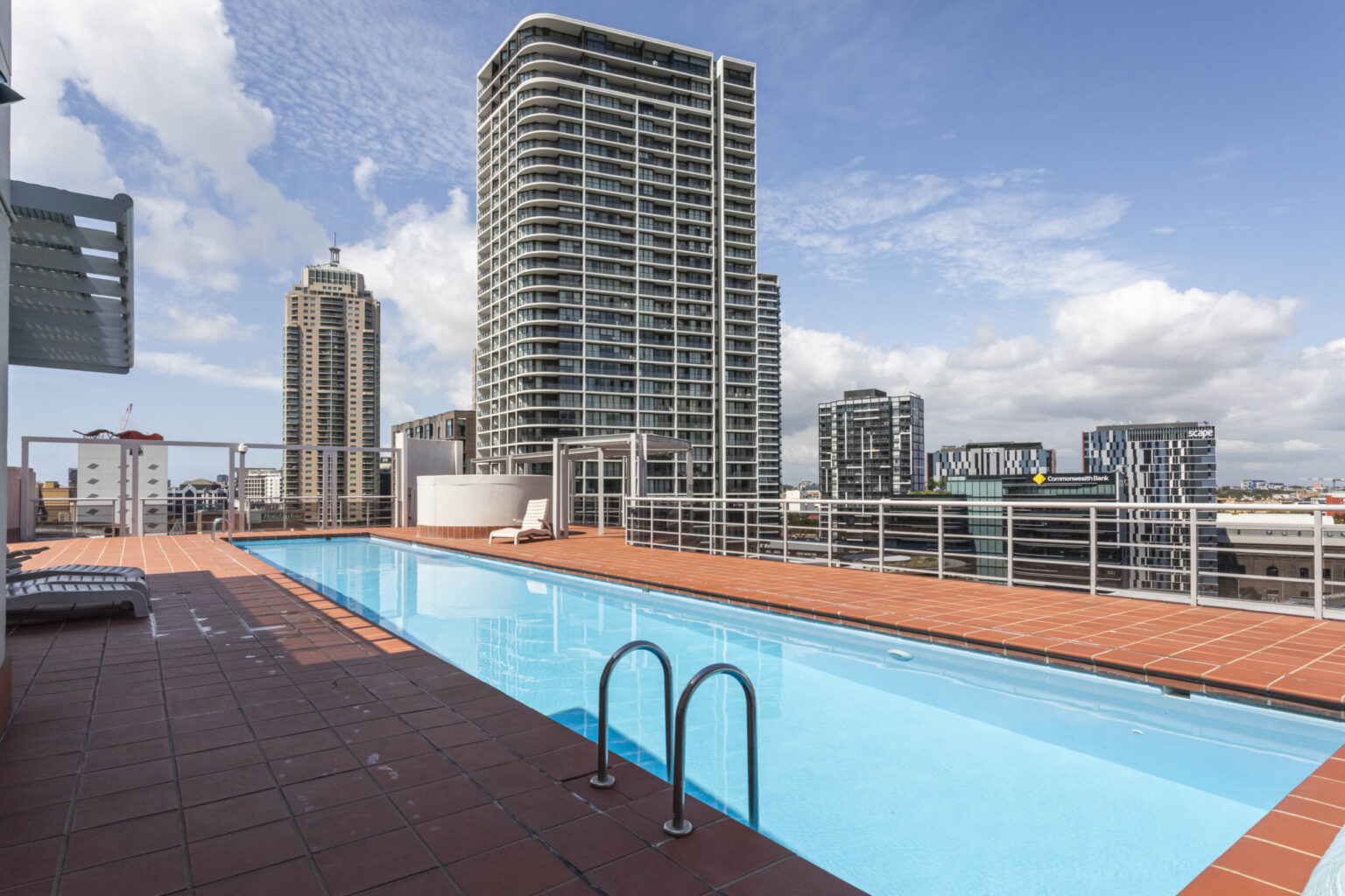 Rooftop pool with the Sydney skyline behind